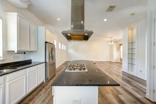 a kitchen with a refrigerator and white cabinets