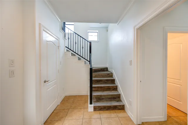 a view of entryway with wooden floor and stairs