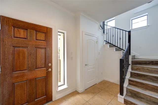 a view of front door with wooden floor and stairs