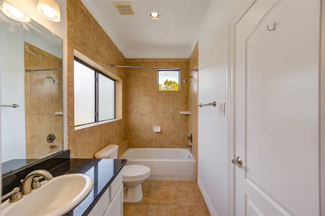 a bathroom with a toilet a sink and a bathtub