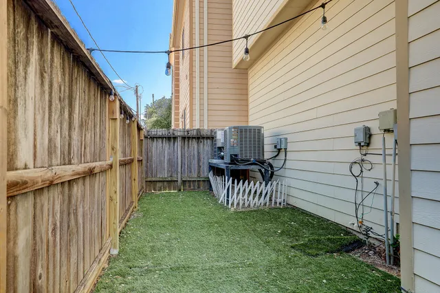 a view of a back yard of the house with a patio