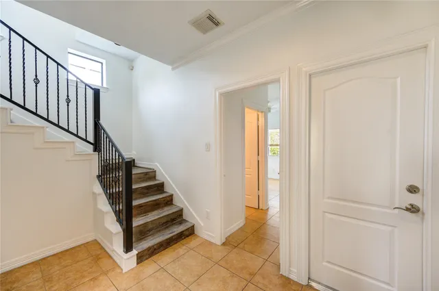 a view of a hallway with entryway wooden floor and front door