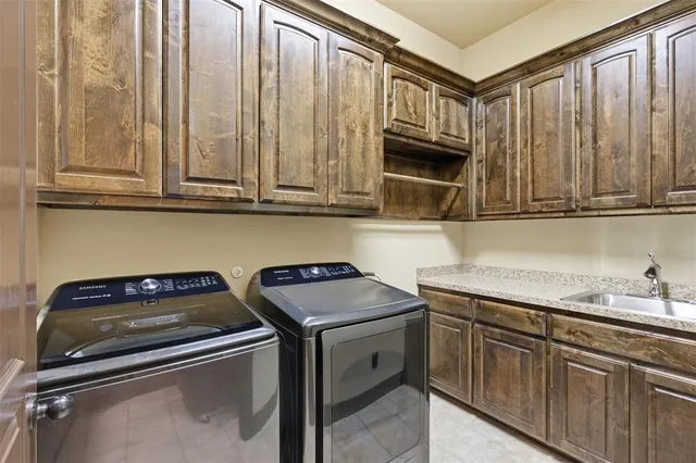 a kitchen with kitchen island granite countertop a stove and a sink