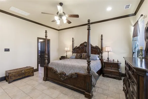 a bedroom with a bed and dresser with mirror