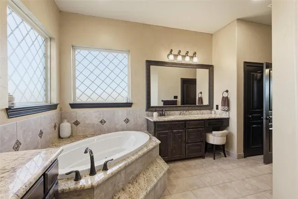a bathroom with a granite countertop sink toilet a mirror and shower