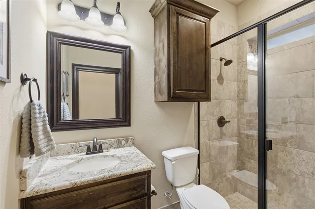 a bathroom with a granite countertop tub sink and mirror