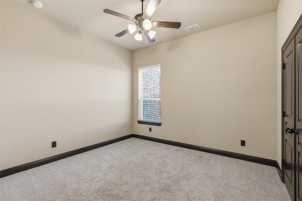 6298 Belz Road Sanger, TX 76266 - Photo 19 of 40 an empty room with a window and a fan
