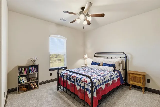 a bathroom with a granite countertop sink toilet mirror and shower