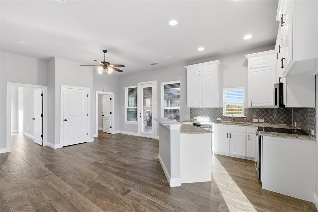 6298 Belz Road Sanger, TX 76266 - Photo 40 of 40 a kitchen with a sink stove and cabinets