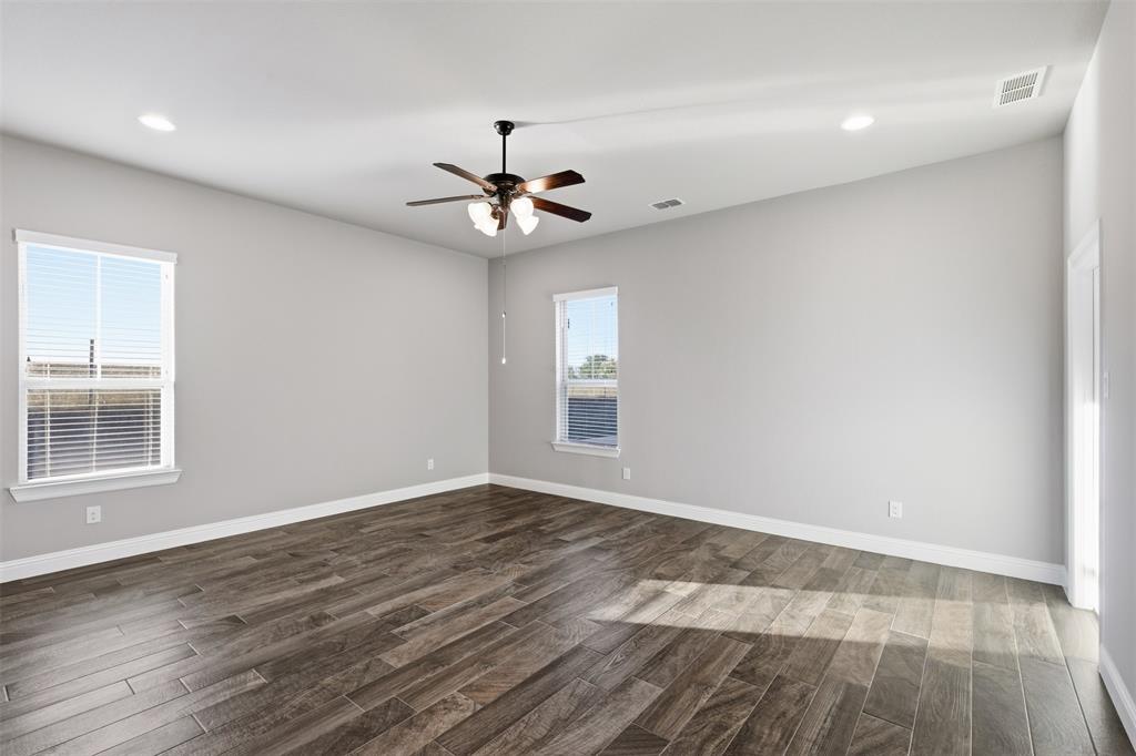 6298 Belz Road Sanger, TX 76266 - Photo 26 of 40 a view of an empty room with wooden floor and a window