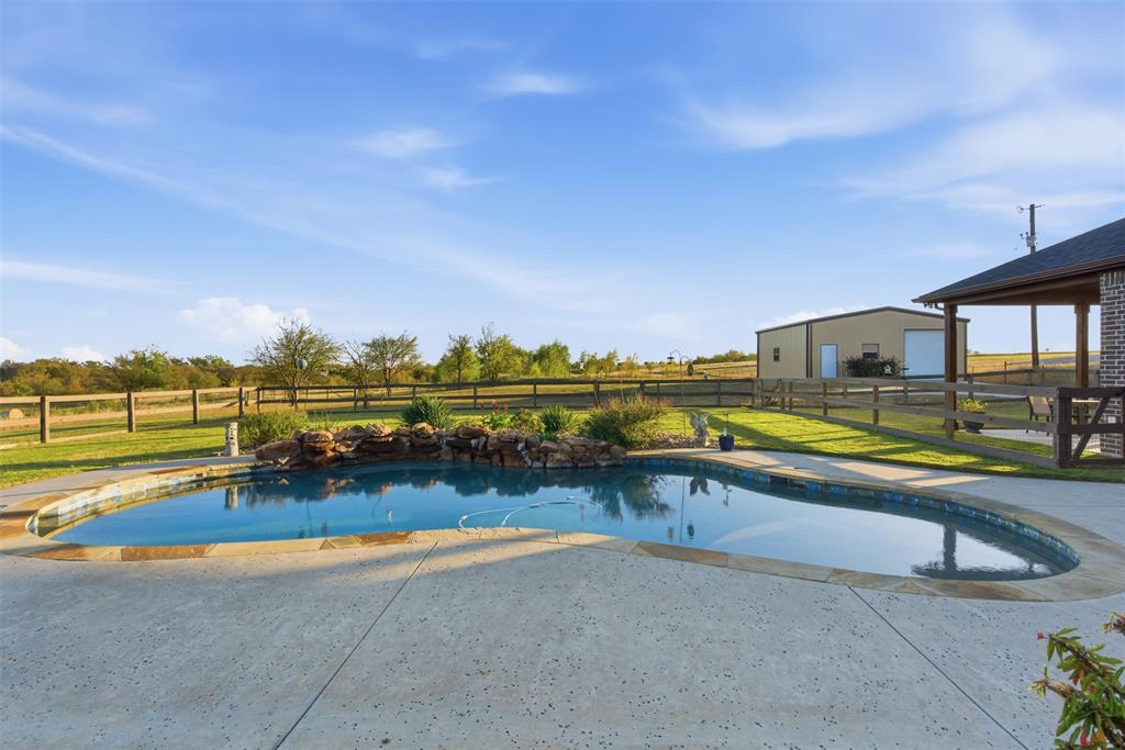 6298 Belz Road Sanger, TX 76266 - Photo 30 of 40 a view of a swimming pool with an ocean view