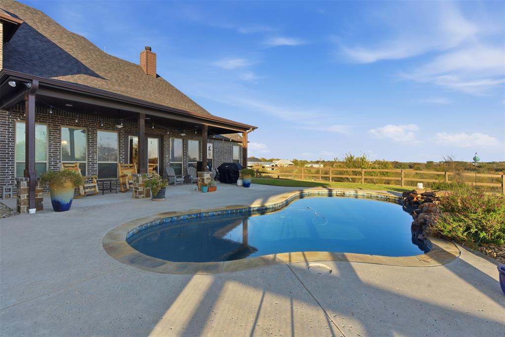 6298 Belz Road Sanger, TX 76266 - Photo 31 of 40 a view of a swimming pool with an outdoor seating