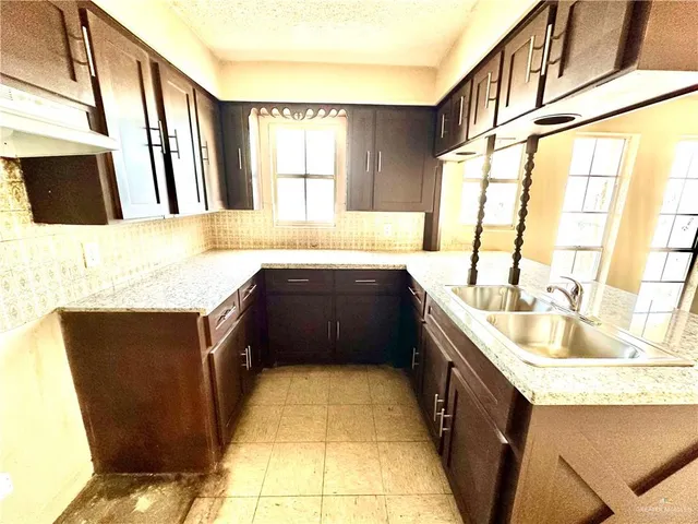 a bathroom with a granite countertop sink and a bathtub