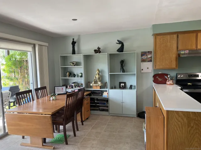 a dining room with furniture and a window