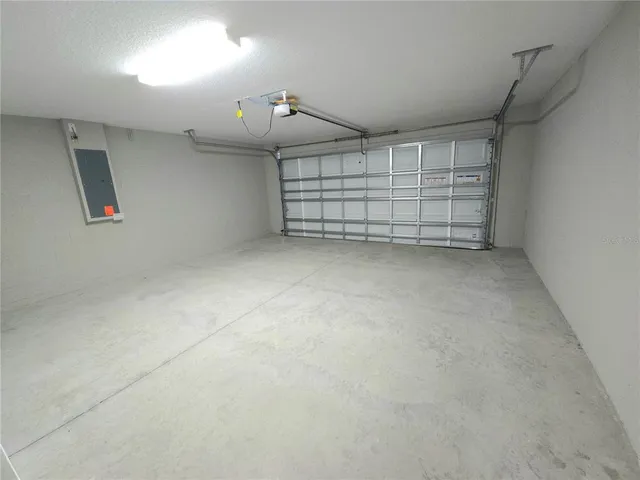 an empty room with white walls and fan