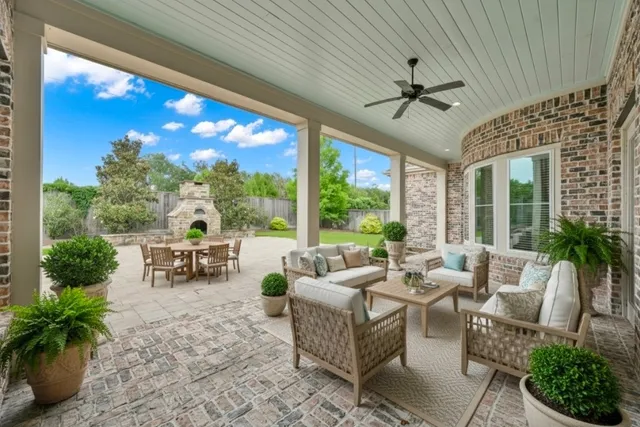 a living room with patio furniture and garden view