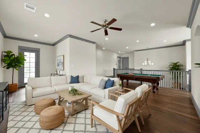a living room with furniture and a wooden floor