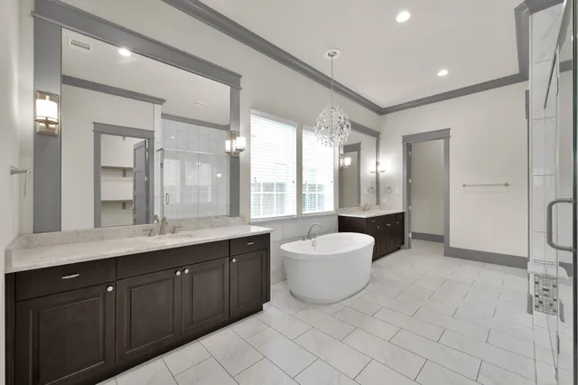a spacious bathroom with a double vanity sink mirror and double