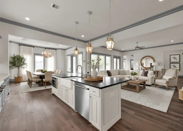 a living room with furniture kitchen view and a large window