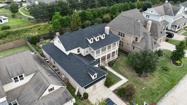 an aerial view of house with backyard