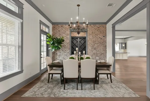a view of a dining room with furniture and a chandelier