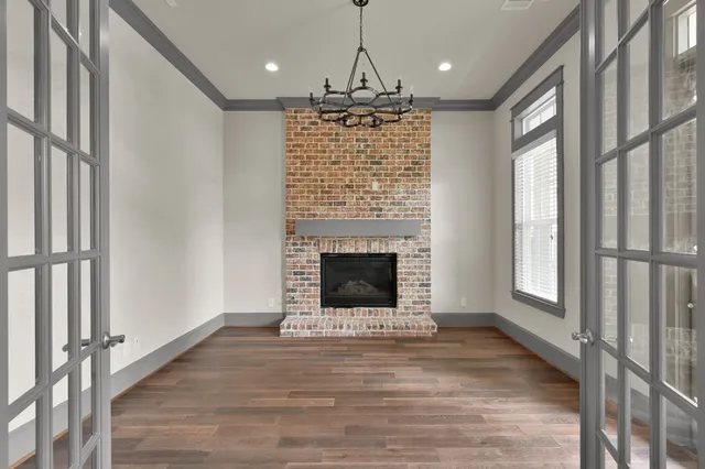 a view of kitchen with granite countertop fireplace and wooden floor