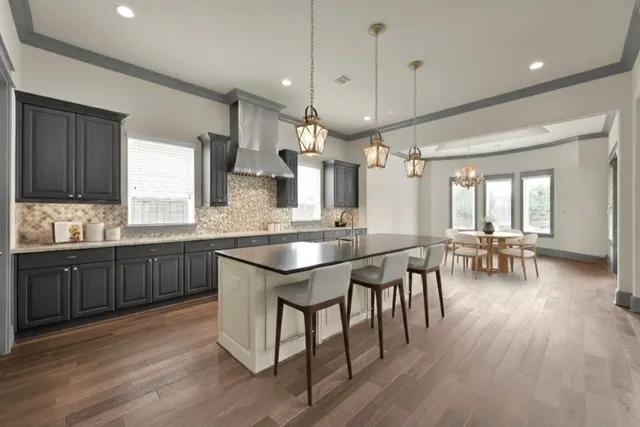 a kitchen with lots of counter space a sink appliances and dining table