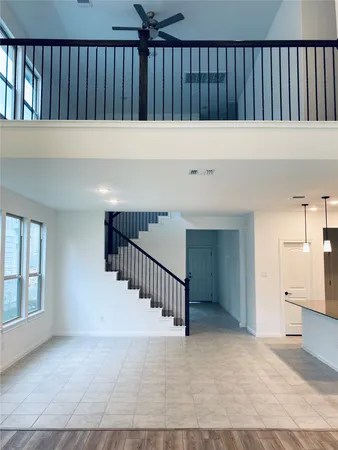 a view of a hallway with wooden floor and staircase