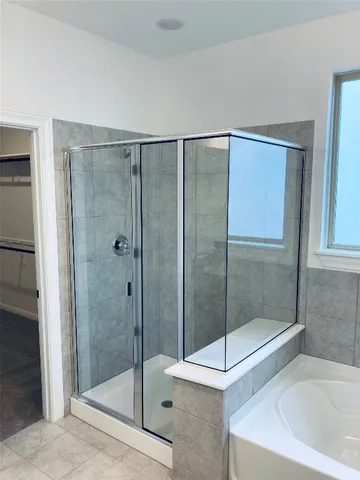 a bathroom with a shower and a sink