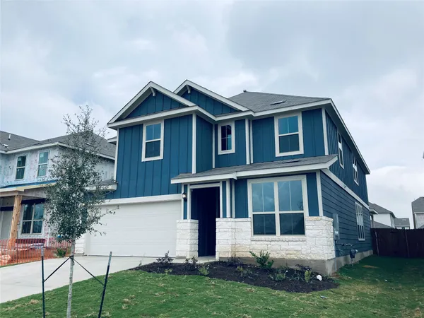 a front view of a house with a yard and porch