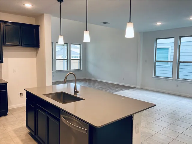 a kitchen with kitchen island a sink a counter space and a window