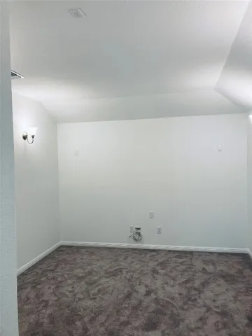 an empty room with closet and a bathroom