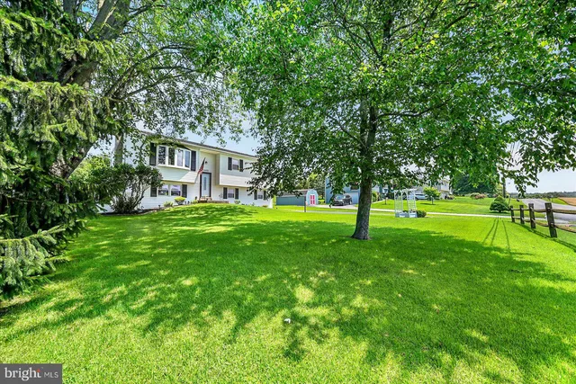 a house with huge green field in front of it