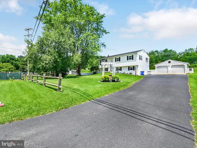 a green field with trees in the background