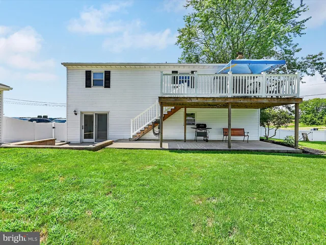 a kitchen with granite countertop a refrigerator and a stove top oven
