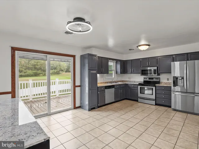 a view of a hallway with a chandelier fan