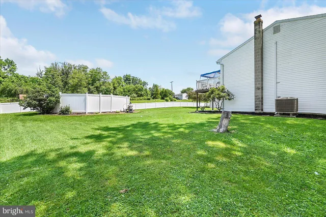 a view of a backyard with a garden and entertaining space