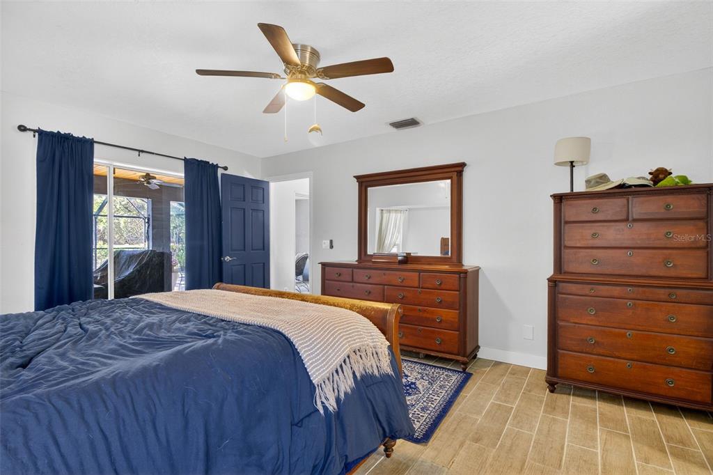 1632 Amstead Street Punta Gorda, FL 33980 - Photo 19 of 50 a bedroom with a bed and a dresser