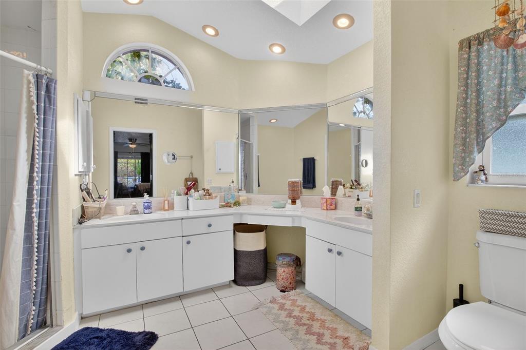 1632 Amstead Street Punta Gorda, FL 33980 - Photo 21 of 50 a spacious bathroom with a double vanity sink a toilet and a mirror
