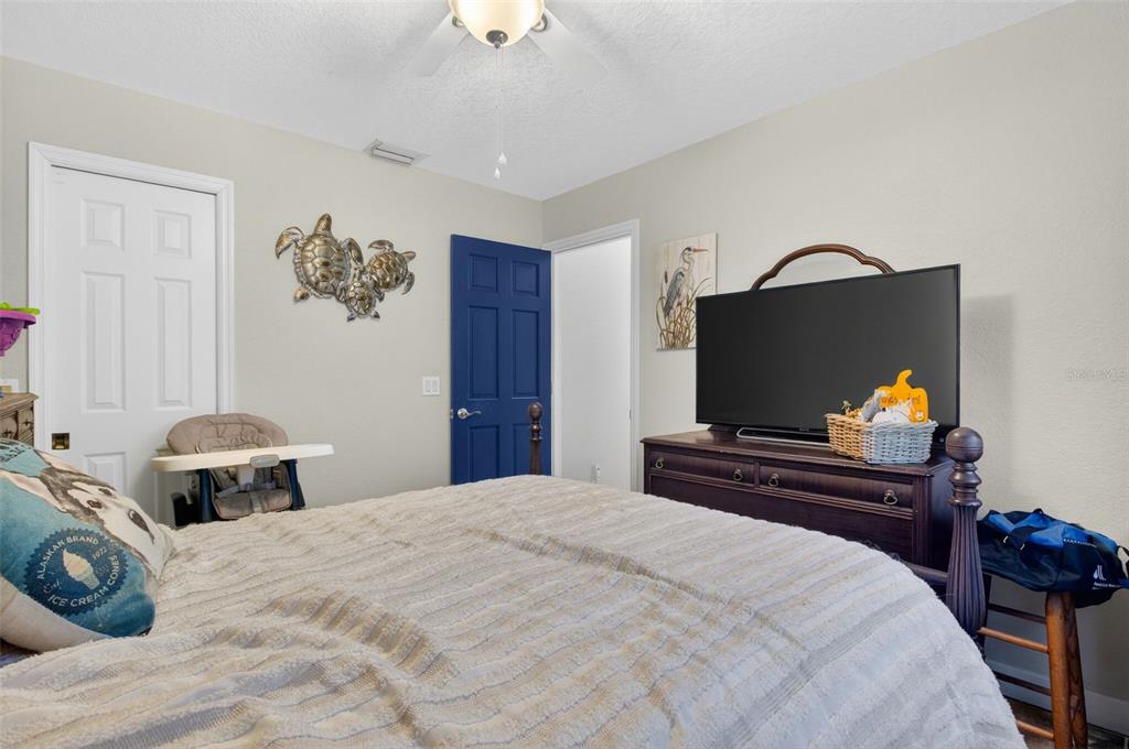 1632 Amstead Street Punta Gorda, FL 33980 - Photo 24 of 50 a bedroom with a bed and a flat screen tv