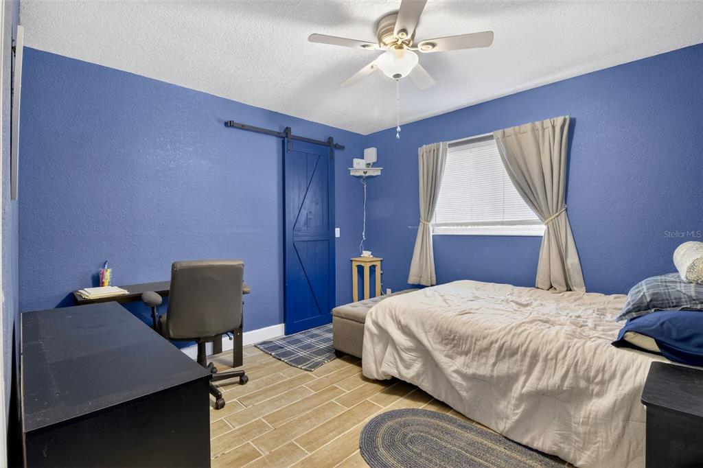 1632 Amstead Street Punta Gorda, FL 33980 - Photo 26 of 50 a bedroom with a bed and a chair
