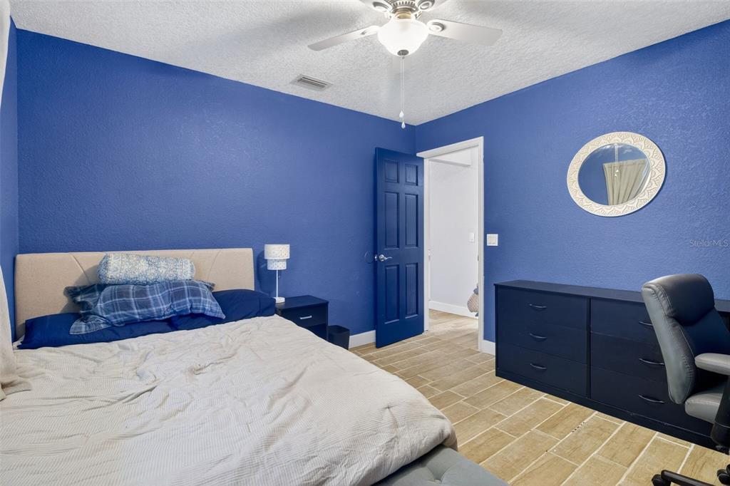 1632 Amstead Street Punta Gorda, FL 33980 - Photo 27 of 50 a bedroom with a large bed and a chandelier