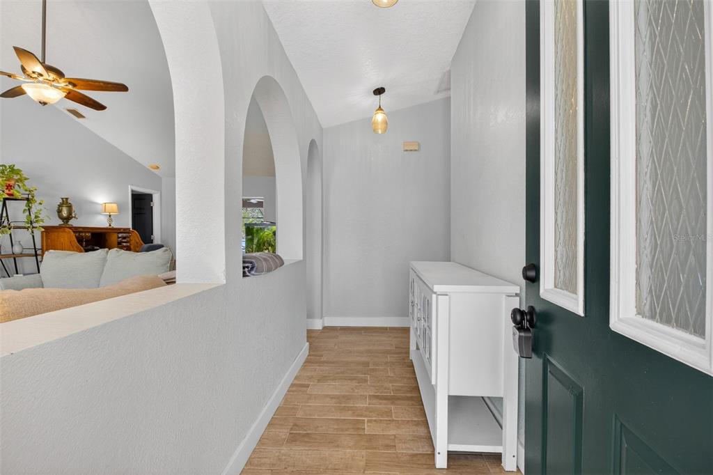1632 Amstead Street Punta Gorda, FL 33980 - Photo 9 of 50 a view of a hallway with wooden floor and staircase