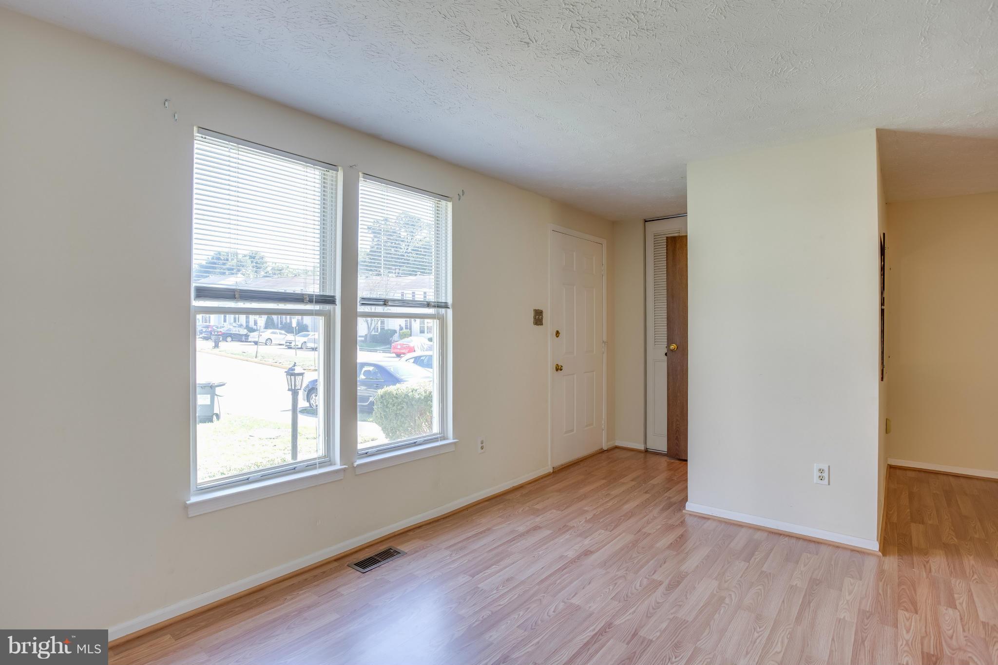 7482 Wounded Knee Road Lorton, VA 22079 - Photo 2 of 29 a view of an empty room with wooden floor and a window