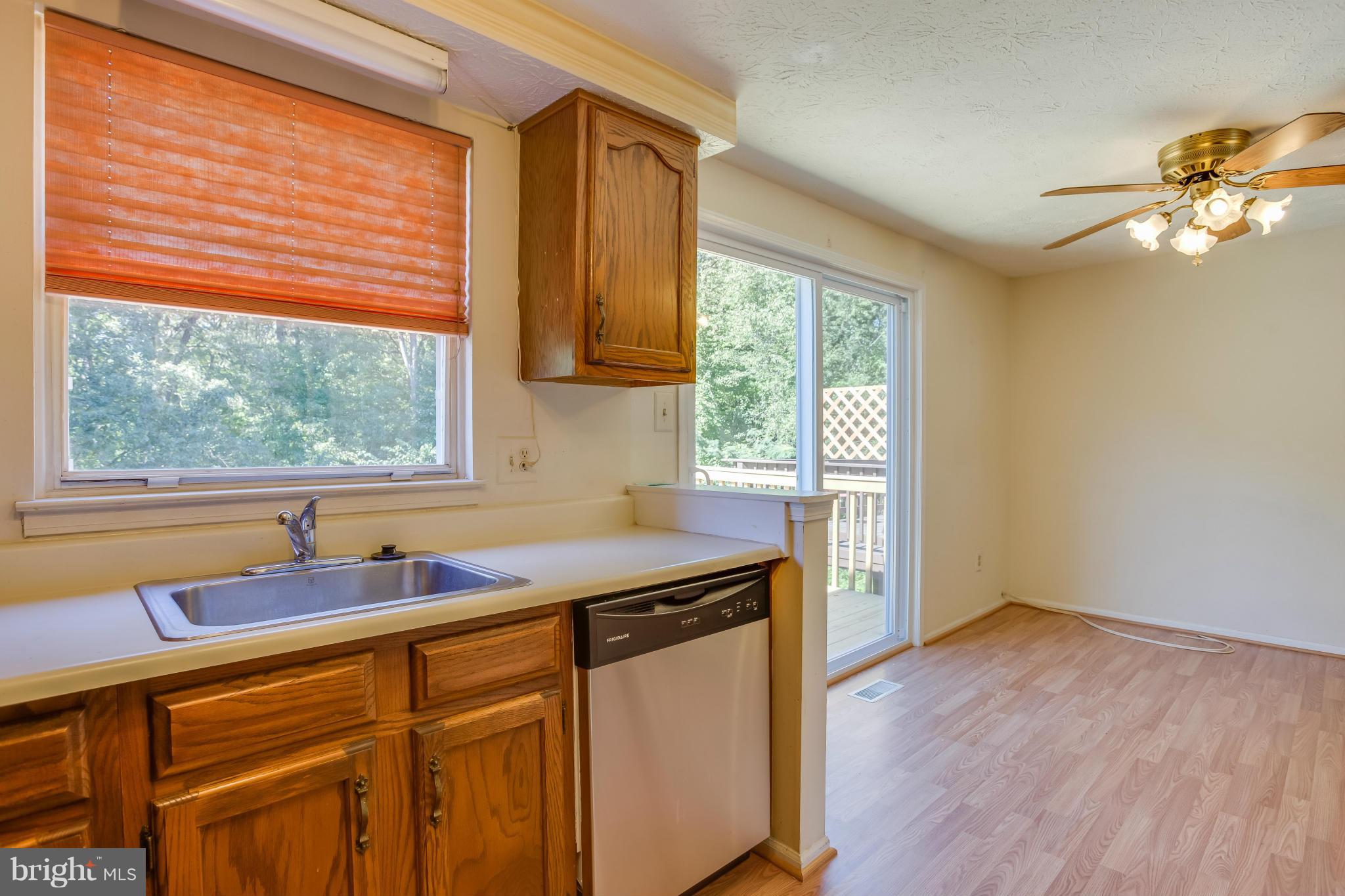 7482 Wounded Knee Road Lorton, VA 22079 - Photo 11 of 29 a kitchen with a sink a window and cabinets
