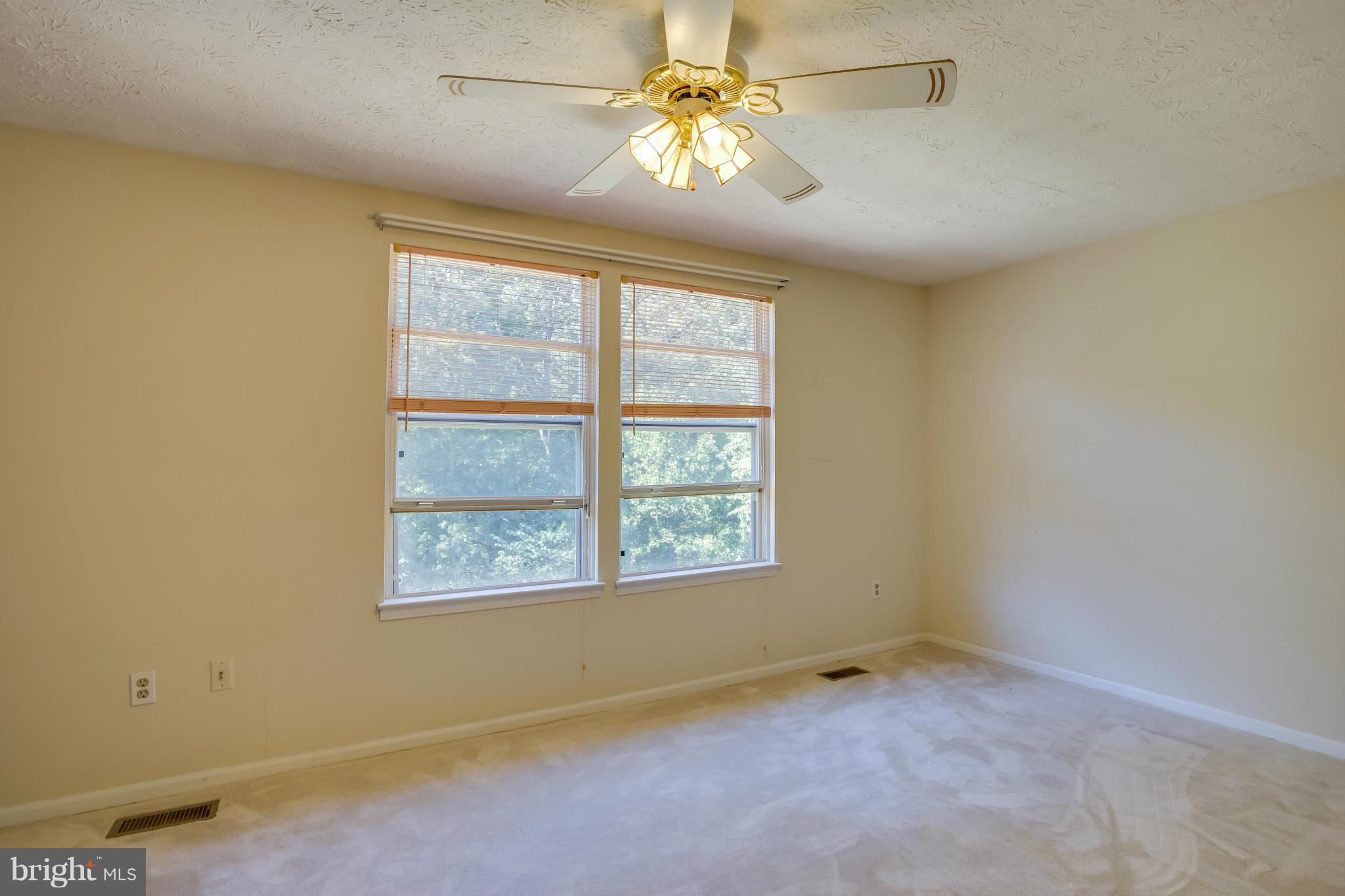 7482 Wounded Knee Road Lorton, VA 22079 - Photo 12 of 29 an empty room with a window and a fan