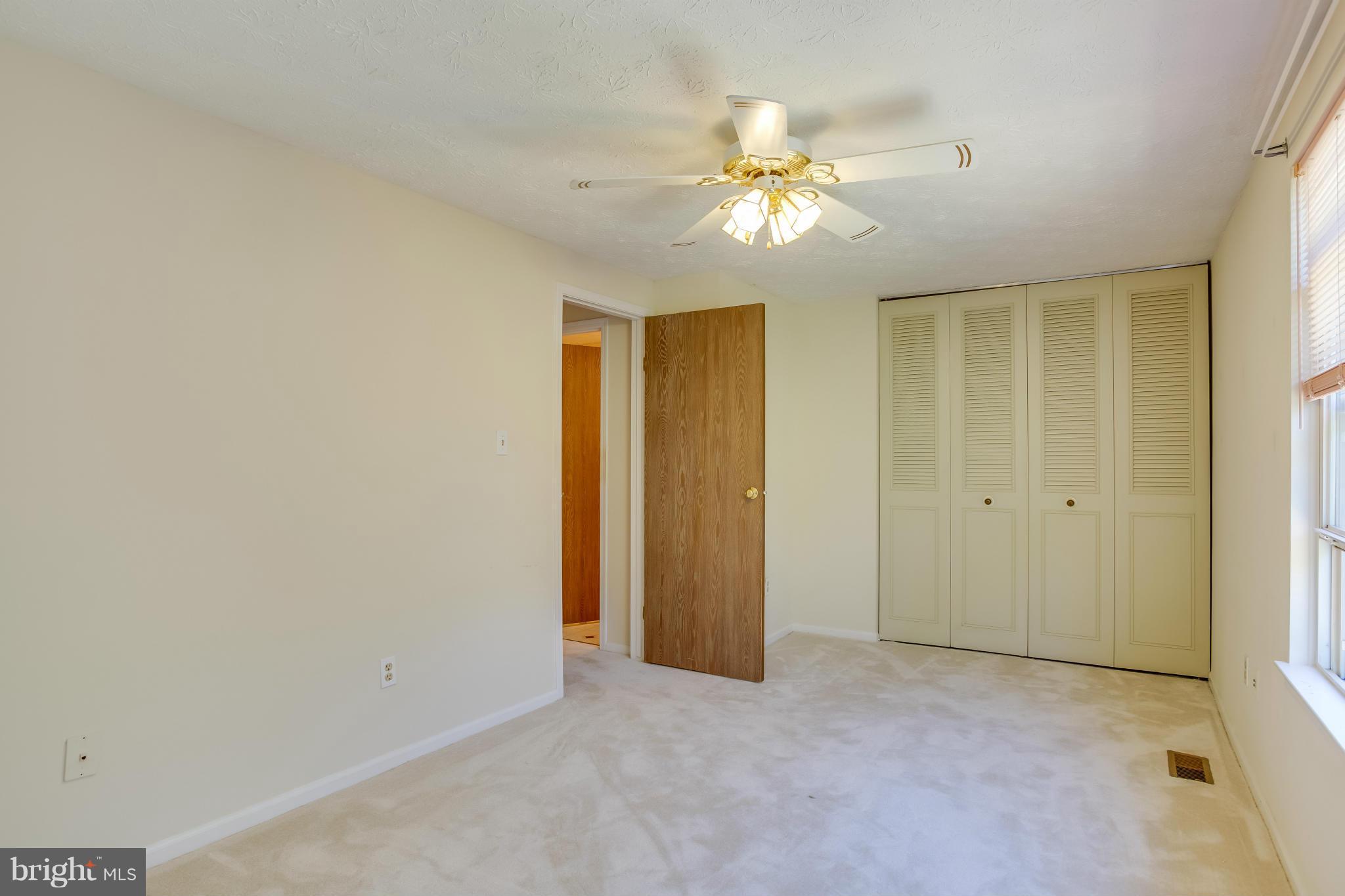 7482 Wounded Knee Road Lorton, VA 22079 - Photo 13 of 29 a view of an empty room with a chandelier fan