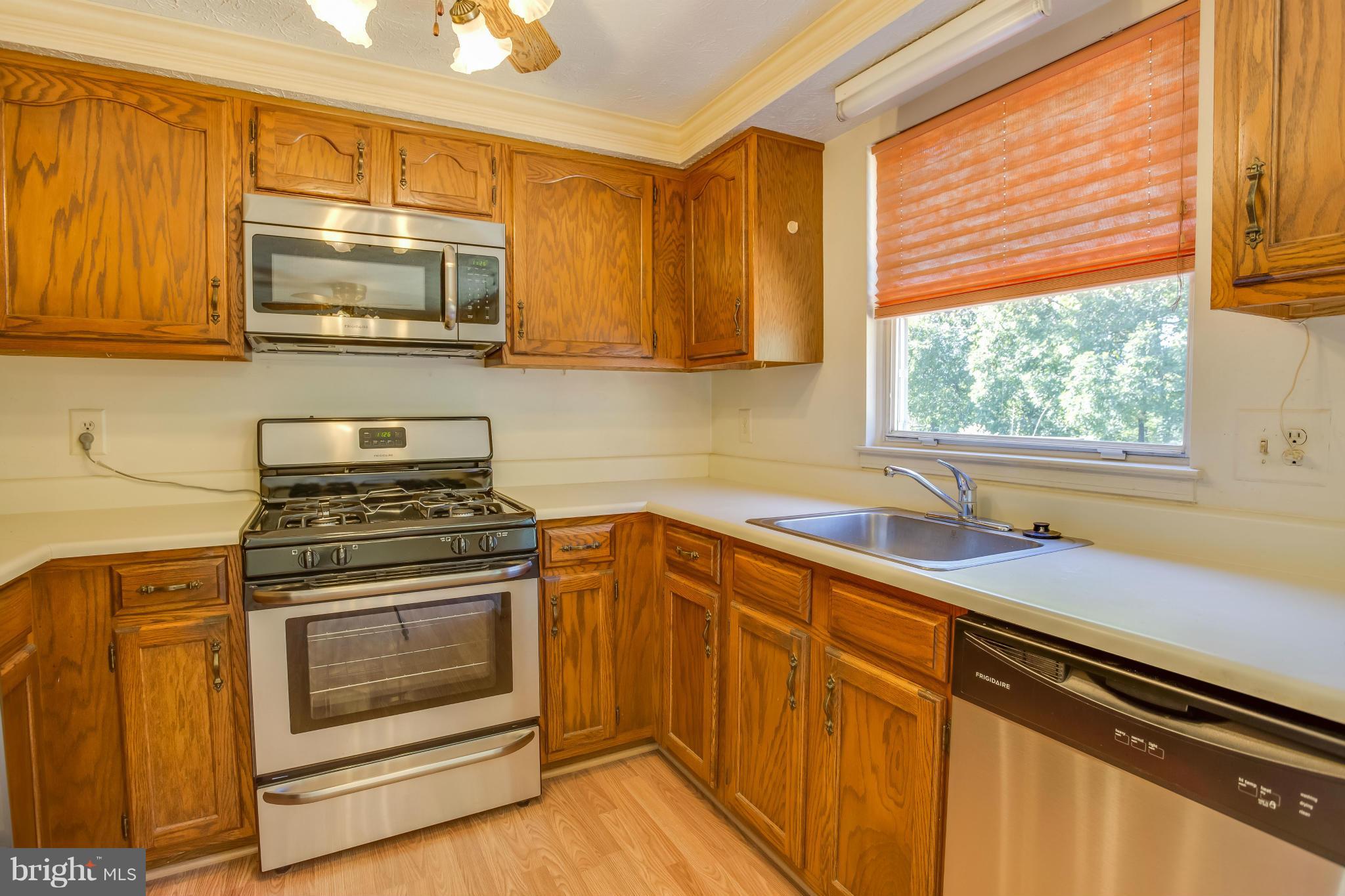 7482 Wounded Knee Road Lorton, VA 22079 - Photo 10 of 29 a kitchen with granite countertop cabinets stainless steel appliances and a sink