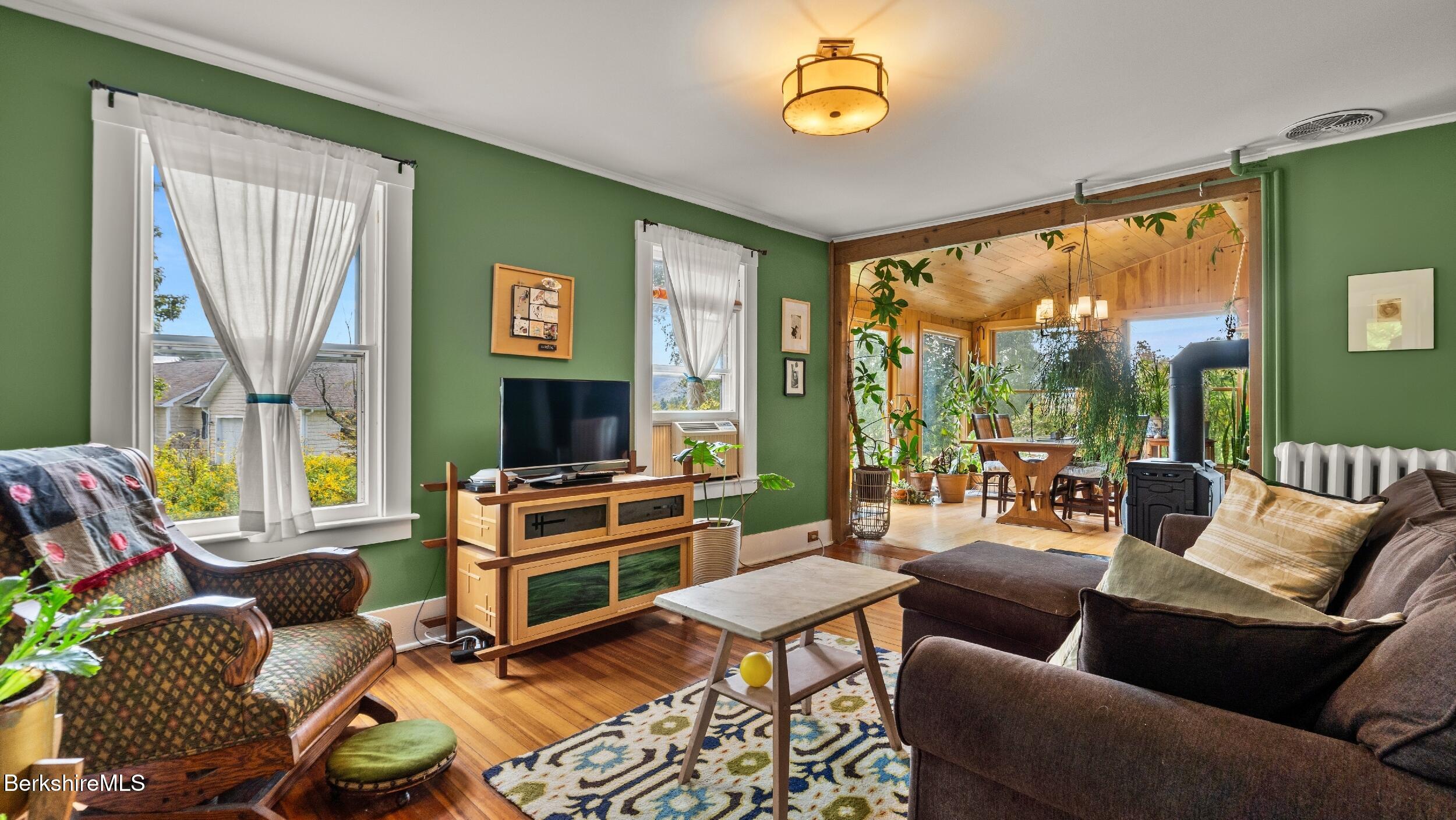 115 Baldwin Hill Road South Egremont, MA 01230 - Photo 17 of 36 a living room with furniture a flat screen tv and a floor to ceiling window