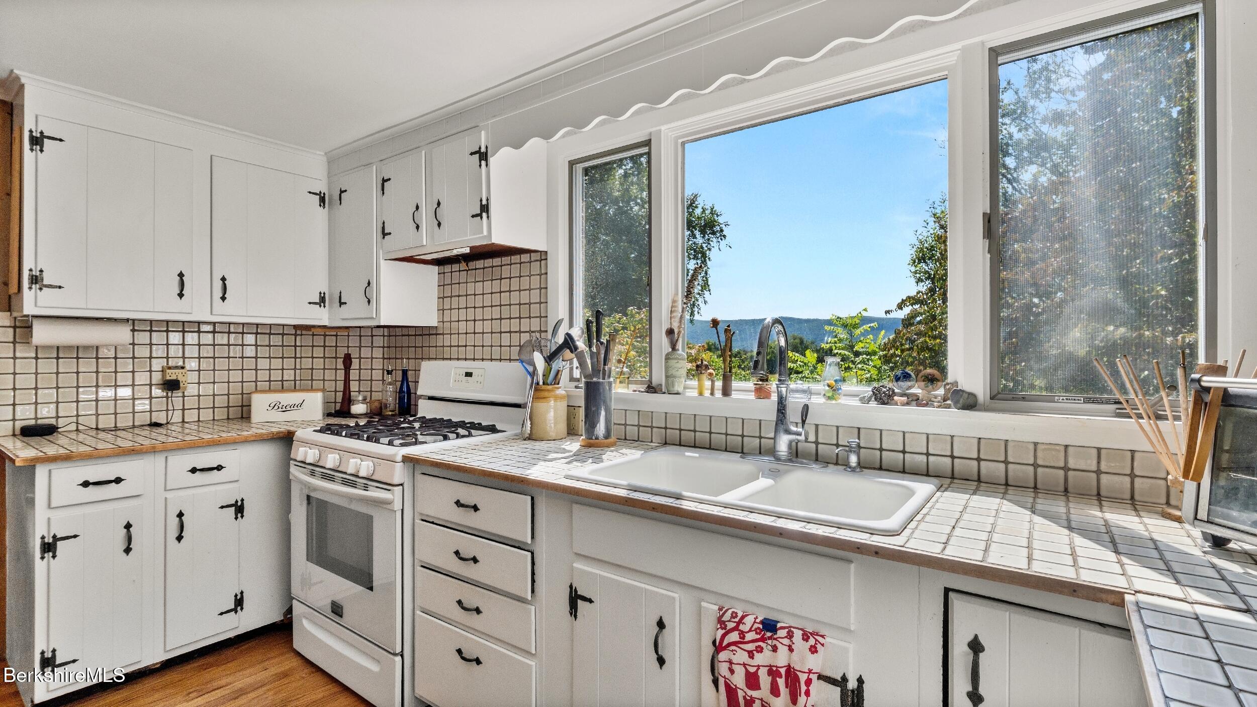 115 Baldwin Hill Road South Egremont, MA 01230 - Photo 26 of 36 a kitchen with a sink stove and cabinets